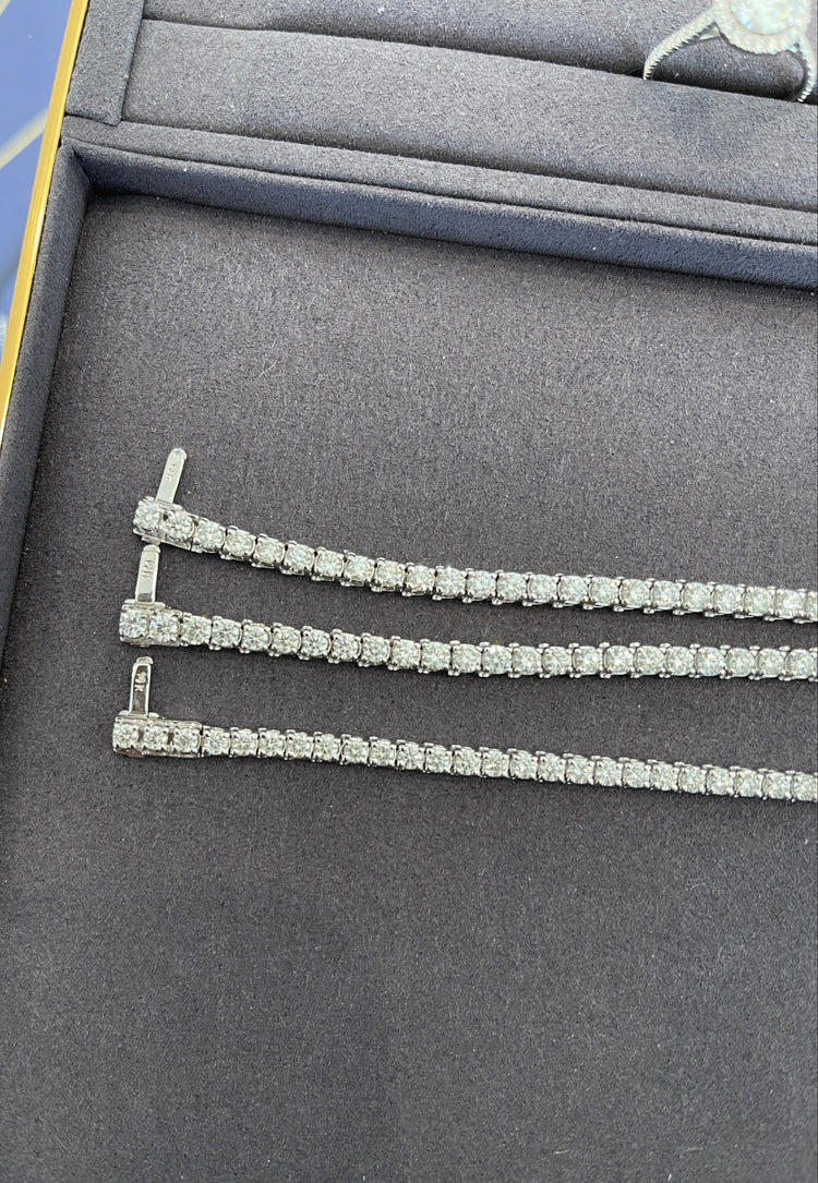 Diamond tennis necklace on a gray jewelry display box